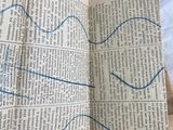 an open book with a blue line drawn on it