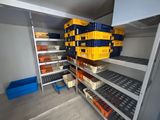 many crates and bins on the shelves in the room