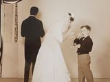 a black and white photo of a man and a woman in a wedding dress