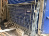 une cage métallique sur laquelle est accrochée une pancarte, devant un mur bleu