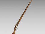 an old rifle with a wooden handle and a wooden barrel