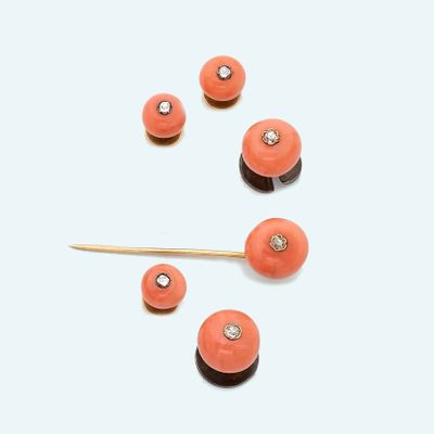 an image of a group of coral colored beads and a wooden stick
