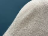 a close up of a person ' s arm with a sweater on
