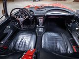 a black and red car inside of a garage