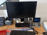 a desk with a computer, keyboard, mouse, printer, and other items on it