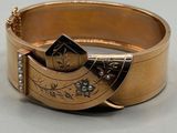 an image of a close up of a gold bracelet on a table