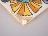 a picture of a tile with a flower design on it