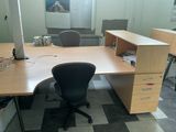 a desk with a chair and a computer on it