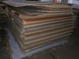 a large pile of wood sitting in a warehouse