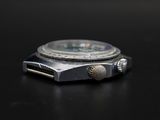 a close up of a watch on a black surface
