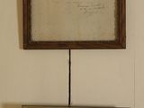 two framed pictures hanging on the wall of a room