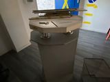a trash can sitting in the middle of a room next to a blue door