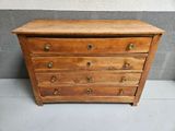 an old wooden chest of drawers sitting on top of a white floor