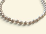 necklace with white pearls on a white background