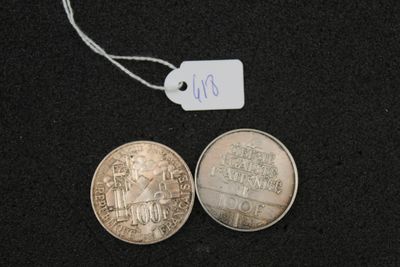 two coins on a black surface with a price tag