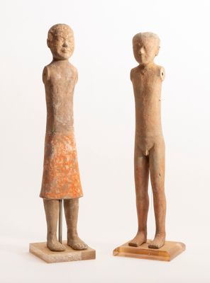 two statues of a man and a woman standing next to each other
