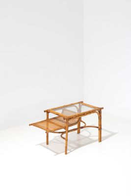 the table is made of wood and has a glass top