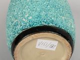 a blue vase that has a label on it