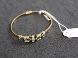 a gold bracelet with blue and white stones on it