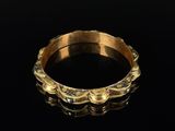 a gold ring with a wavy design on it