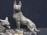sculpture of two dogs sitting on a marble base on a black background