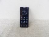 a cell phone sitting on a table with a clock on it