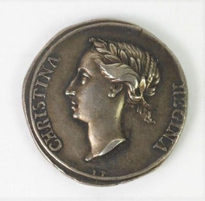 a close up of a coin with a woman ' s head on it