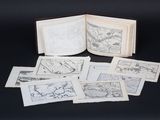 an open book sitting on top of a black table next to a pile of drawings