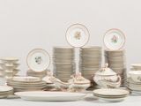 a lot of plates and bowls on the table