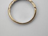 a close up of a gold ring on a white surface