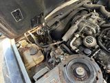 a dirty engine of a car that is sitting in the dirt
