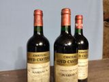 three bottles of wine sitting on top of a table next to each other