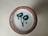 a picture of a ceramic vase with a green and white design on it