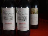 several bottles of wine are lined up on a table