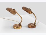 a pair of brass table lamps on a white surface