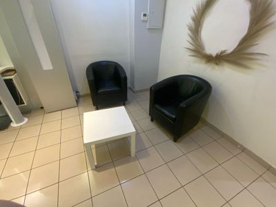 Une paire de fauteuils Skaï et une table basse