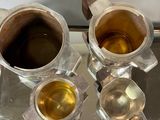 two cups of tea on a tray with a spoon