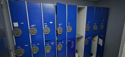 several blue lockers are lined up in a row in a room