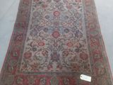a red and blue rug on display in a store