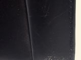 the black leather wallet is open and ready to be used