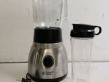 a blender that is sitting on a table next to a cup