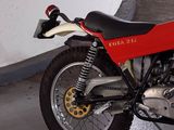 a red and black motorcycle parked in a parking garage