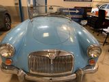a blue car that is parked in a garage