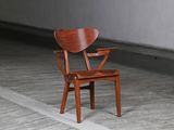 a wooden chair that is sitting in the middle of a room