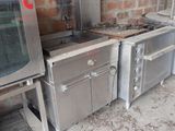 several stainless steel appliances are lined up against a brick wall