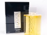 an image of a bottle of perfume sitting on a white surface