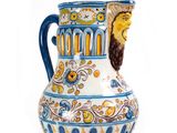a blue and white vase with a lion head on it