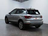 the rear end of a silver suv parked in a garage