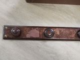 three buttons on the back of a metal plate