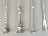 four spoons and two spoon spoons on a table